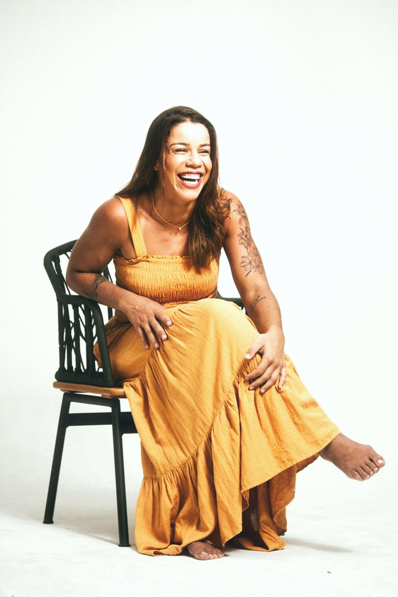 Jaqueline laughing in a yellow dress